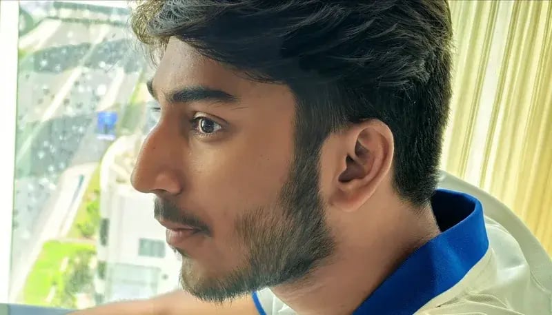 Nikesh looking through a window